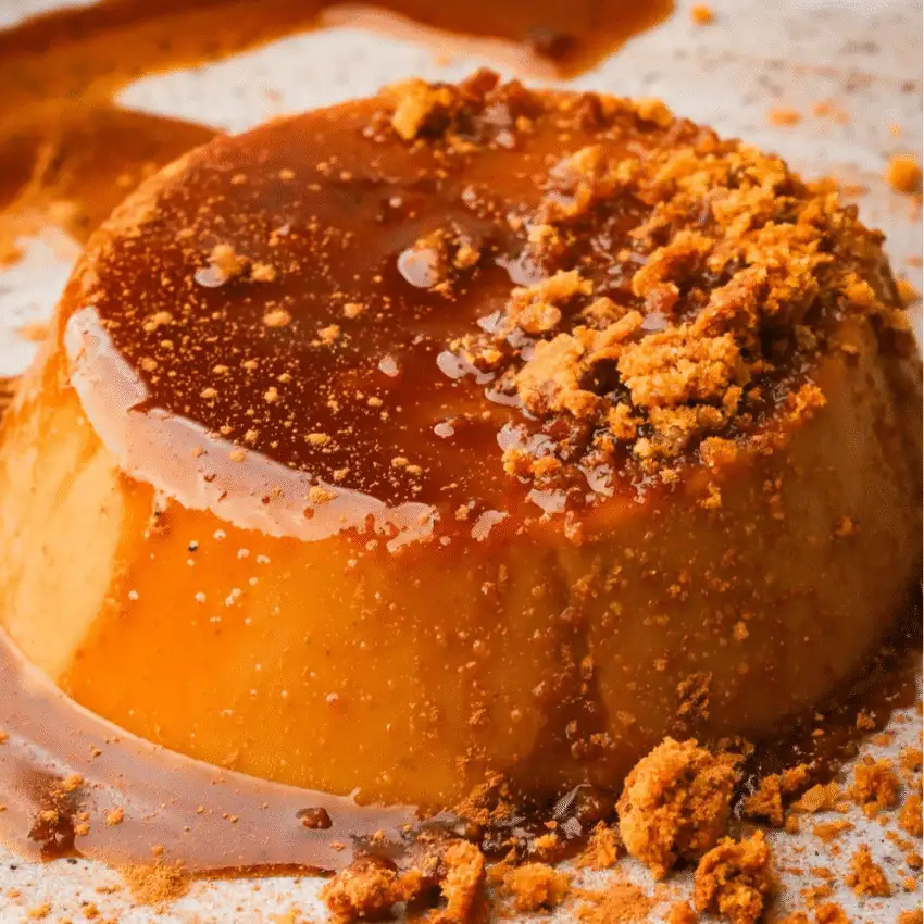 Vegan pumpkin flan topped with rich caramel sauce and crushed cookies—an elegant and creamy fall dessert made with leftover pumpkin puree.