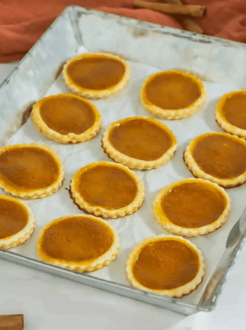 Mini pumpkin pie cookies with fluted crusts made using leftover pumpkin puree—perfect for fall baking and ideas on what to make with leftover pumpkin puree.