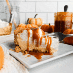 Slice of no-bake pumpkin pie topped with whipped cream and drizzled caramel sauce, served on a white plate—an indulgent way to use leftover pumpkin puree.