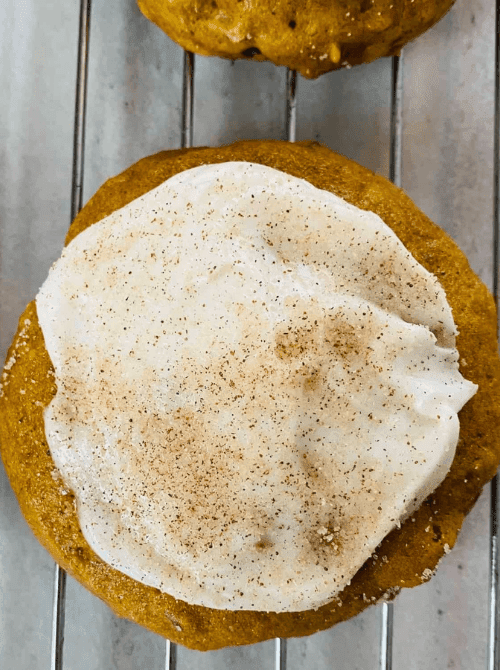 Frosted pumpkin cookie made with leftover pumpkin puree, perfect for fall baking and anyone searching for what to make with leftover pumpkin puree.
