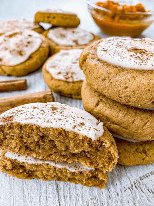 Frosted pumpkin cookies made with leftover pumpkin puree, shown with a soft, cakey texture—perfect for anyone searching what to make with leftover pumpkin puree.
