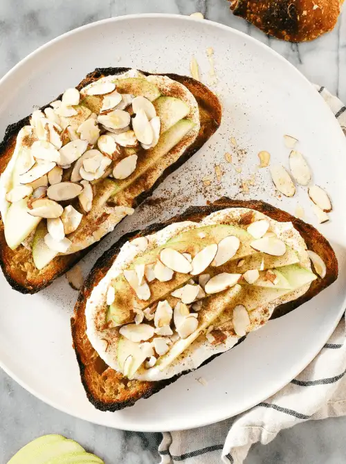Toasted sourdough slices topped with fresh apple slices, whipped ricotta, cinnamon, and sliced almonds—an elegant, savory-sweet twist on things to make with apples and a go-to for easy fall recipes.