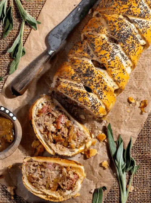 Golden braided pastry filled with sausage, apple, and herb stuffing, topped with poppy seeds—flaky, savory, and one of the most delicious things to make with apples for easy fall recipes and festive gatherings.