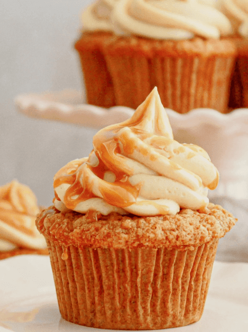 Spiced apple cupcake topped with caramel-swirled buttercream frosting – a cozy and simple fall treat, and one of the sweetest things to make with apples this season.