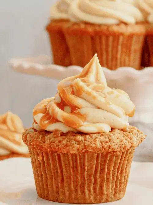 Spiced apple cupcake topped with caramel-swirled buttercream frosting – a cozy and simple fall treat, and one of the sweetest things to make with apples this season.