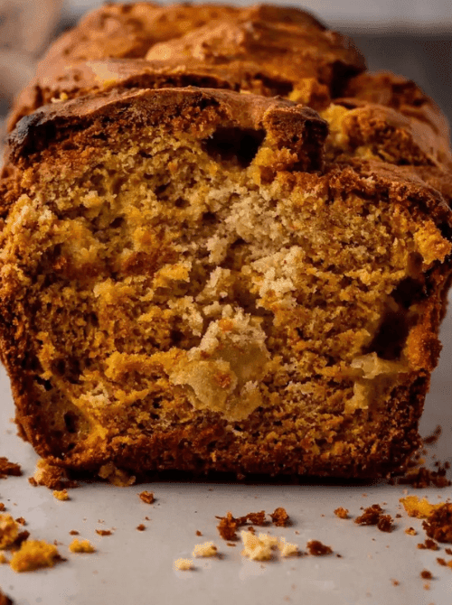 Close-up of a sliced pumpkin bread loaf with a golden, marbled crumb — a flavorful example of what to do with leftover pumpkin puree and a creative twist for easy pumpkin bread recipes.