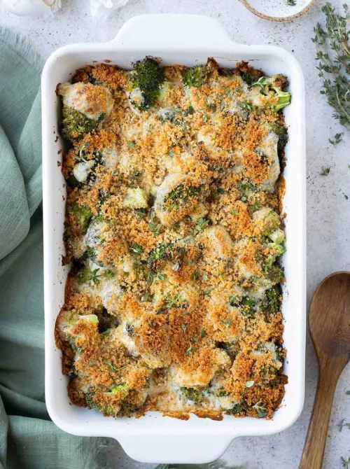 Broccoli au gratin casserole with golden breadcrumb topping in a white baking dish—an easy, comforting choice for Budget-Friendly Thanksgiving Vegetable Sides.