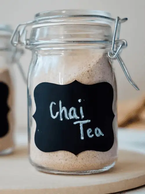 Homemade chai tea mix in a mason jar with a chalkboard label, a cozy idea for DIY Christmas gifts and mason jar recipes.