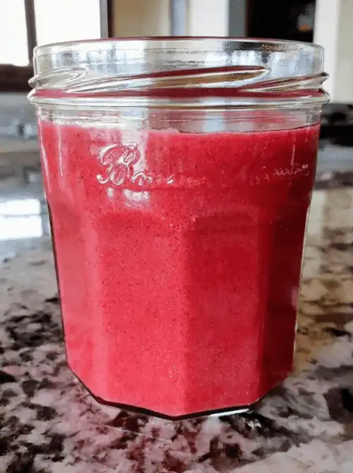 Glass jar filled with homemade cranberry sauce – a simple idea for what to make with Thanksgiving leftovers and recipes that stretch your budget.