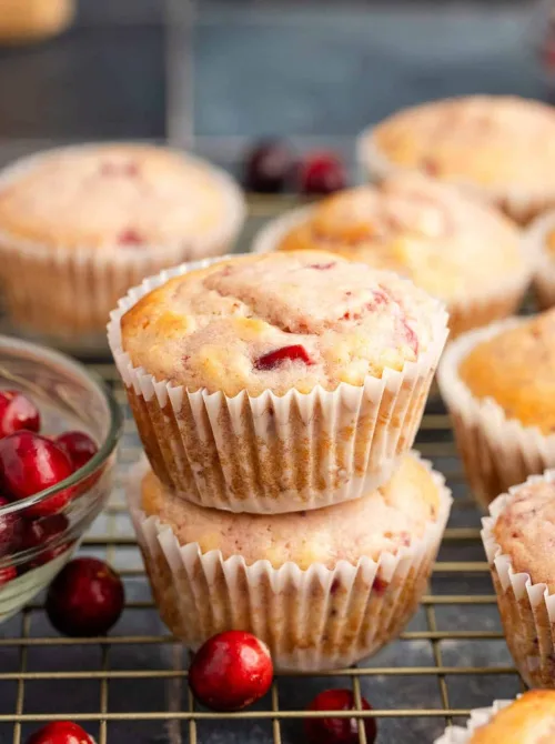Fresh cranberry muffins stacked on a cooling rack – an easy idea for what to make with Thanksgiving leftovers and recipes that stretch your budget.
