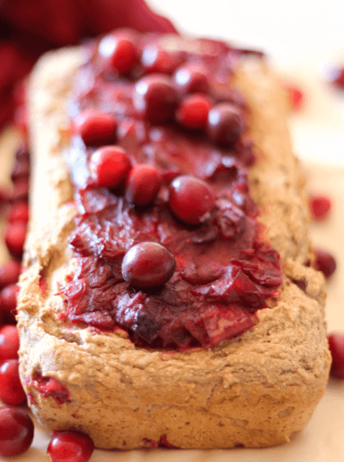 Homemade cranberry bread topped with whole cranberries – a festive idea for what to make with Thanksgiving leftovers and recipes that stretch your budget.