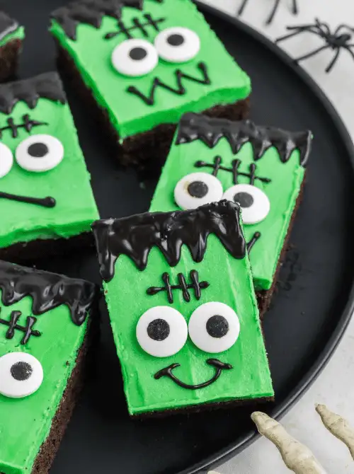 Frankenstein brownie bars with bright green frosting, candy eyes, and black icing details—an easy and festive Halloween treat for parties and kids' dessert tables.