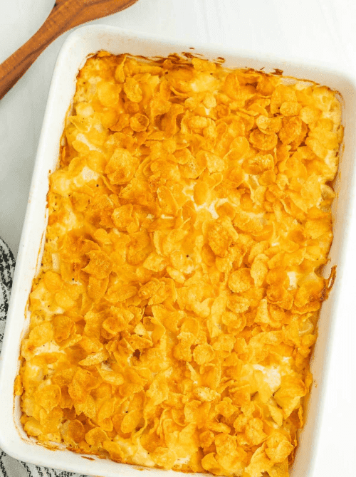 Golden-topped funeral potatoes casserole in a white baking dish, featured in Budget-Friendly Thanksgiving Sides and Easy Potato Recipes for a cheesy holiday favorite.