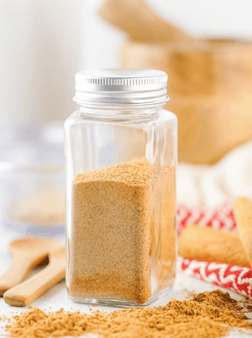 Homemade gingerbread spice mix in a glass jar, a warm and aromatic mason jar recipe that makes a festive DIY Christmas gift.