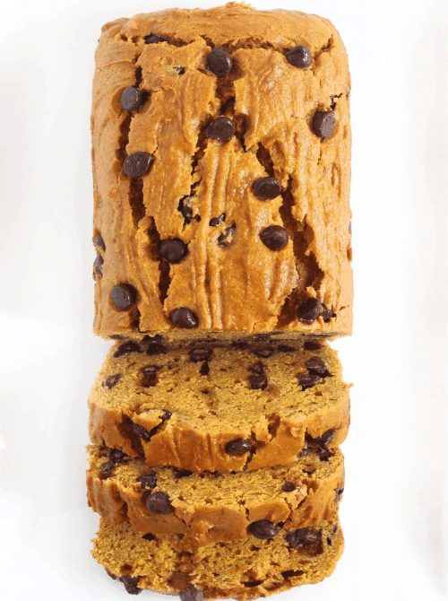 Thick slices of soft pumpkin bread studded with chocolate chips, showing a moist texture and rich fall flavor, perfect for a cozy homemade treat.