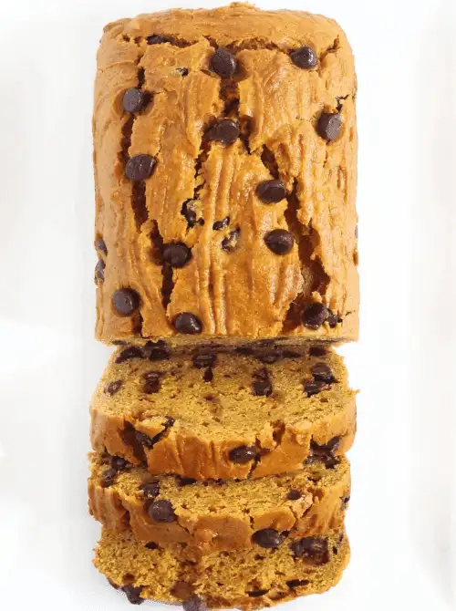 Thick slices of soft pumpkin bread studded with chocolate chips, showing a moist texture and rich fall flavor, perfect for a cozy homemade treat.