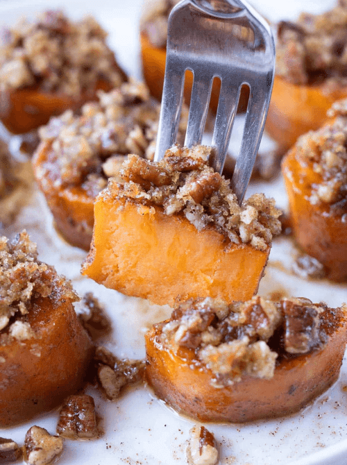 Close-up of pecan-crusted sweet potato rounds on a fork, part of Budget-Friendly Thanksgiving Sides and Easy Potato Recipes for the holiday table.