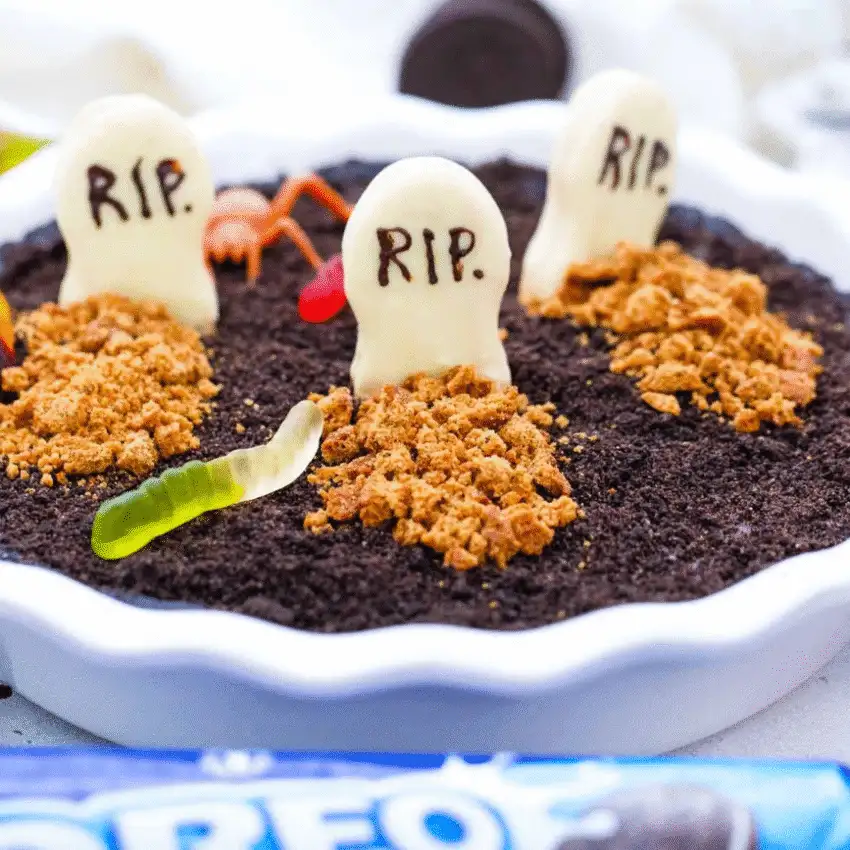 Assorted Halloween-themed chocolate-dipped Oreo cookies decorated with colorful orange, green, purple, and black sprinkles, perfect for no-bake Halloween treats.