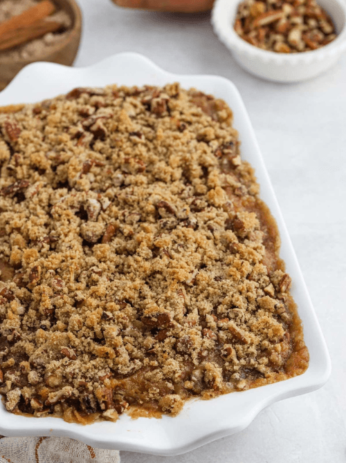 Sweet potato casserole with brown sugar pecan crumble in a white baking dish, part of Budget-Friendly Thanksgiving Sides and Easy Potato Recipes for a warm holiday favorite.