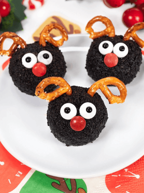 Reindeer cookie balls decorated with pretzels and candy, a playful DIY Christmas gift idea featuring cookies and bars.