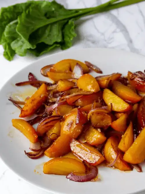 Maple-glazed roasted beets and caramelized red onions served on a white plate—an eye-catching and Budget-Friendly Thanksgiving Vegetable Side perfect for holiday tables.