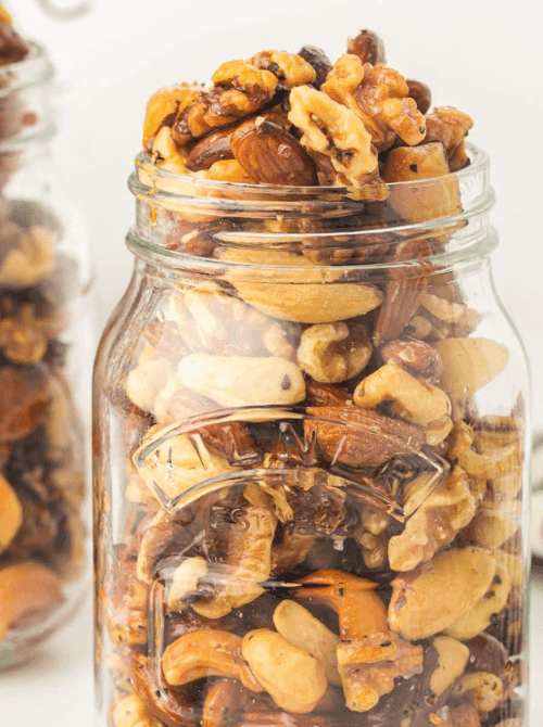 Roasted mixed nuts packed in a mason jar, a savory and protein-rich mason jar recipe that makes an easy DIY Christmas gift.