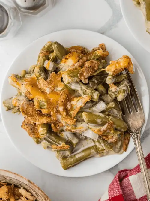 Classic green bean casserole with cheddar cheese, creamy sauce, and crispy fried onions—an easy, nostalgic pick for Budget-Friendly Thanksgiving Vegetable Sides.