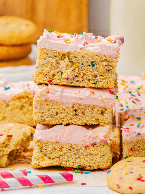 Stack of frosted sugar cookie bars with sprinkles, a colorful DIY Christmas gift idea featuring cookies and bars.