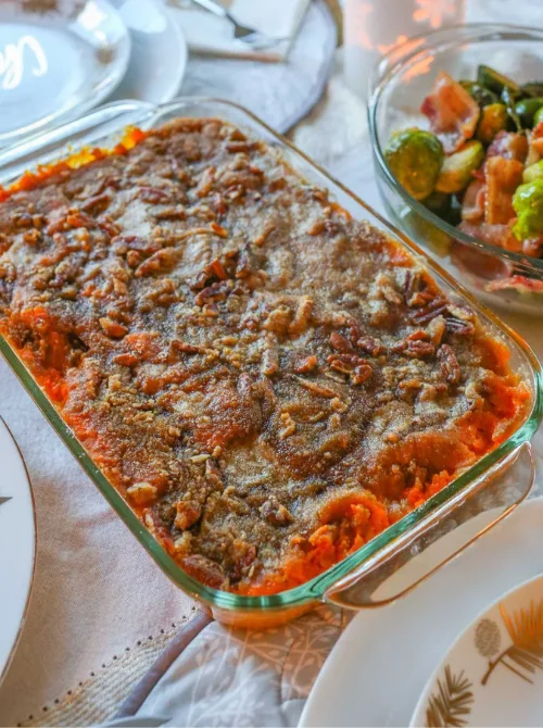Sweet potato casserole with pecan topping in a glass baking dish, part of Budget-Friendly Thanksgiving Sides and Easy Potato Recipes for a classic holiday dish.