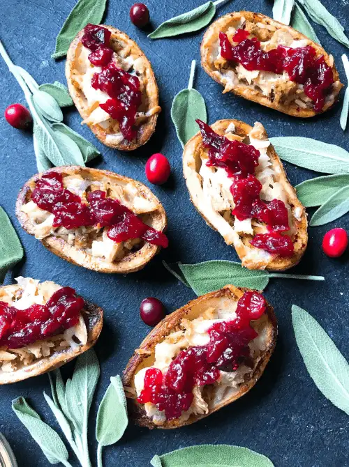 Crispy potato skins stuffed with turkey, stuffing, and cranberry sauce – a creative idea for what to make with Thanksgiving leftovers and recipes that stretch your budget.