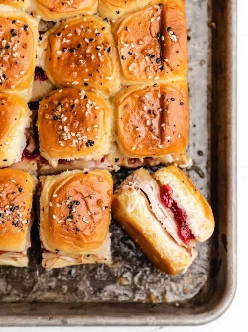 Pull-apart turkey cranberry sliders on buttery rolls – a tasty idea for what to make with Thanksgiving leftovers and recipes that stretch your budget.