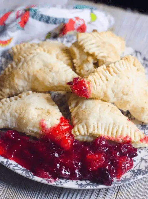 Flaky cranberry hand pies with filling spilling out – a festive idea for what to make with Thanksgiving leftovers and recipes that stretch your budget.