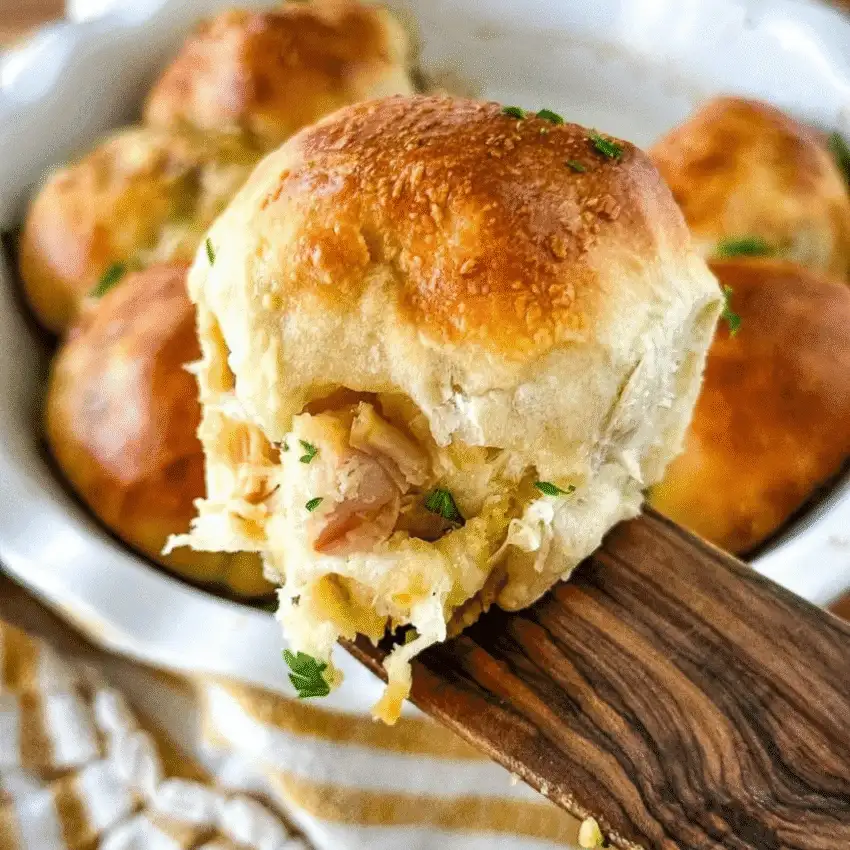 Fluffy golden dinner roll stuffed with turkey and cheese – a cozy idea for what to make with Thanksgiving leftovers and recipes that stretch your budget.