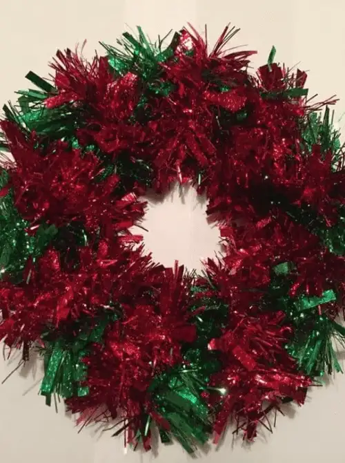 Dollar Store Christmas wreath made with red and green tinsel, a budget-friendly option for festive Christmas DIY decor.D