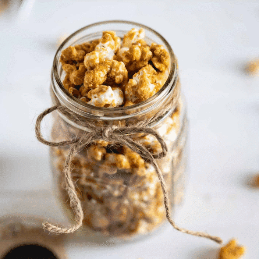 DIY Christmas gift idea: caramel popcorn packed in a mason jar and tied with rustic twine.