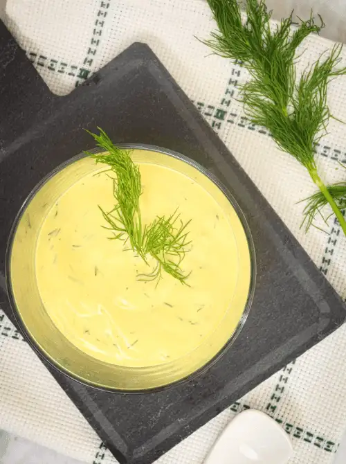 Creamy dill sauce in a glass bowl garnished with fresh dill, a light and flavorful option for Party Dips for the Holidays and Cheesy Dips.