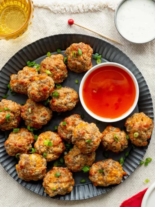 Cheddar Sausage Balls served with dipping sauce — a crowd-favorite, budget-friendly appetizer for Christmas party food ideas that’s easy to make without Bisquick, perfect for holiday gatherings, game day spreads, and quick finger food appetizers everyone will love.