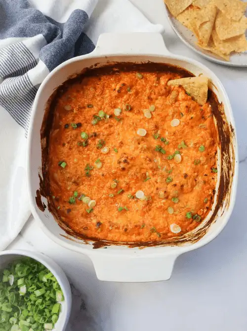 Cheesy vegetarian white bean buffalo dip baked until golden and topped with green onions, a hearty choice for Party Dips for the Holidays with Unique Twists.