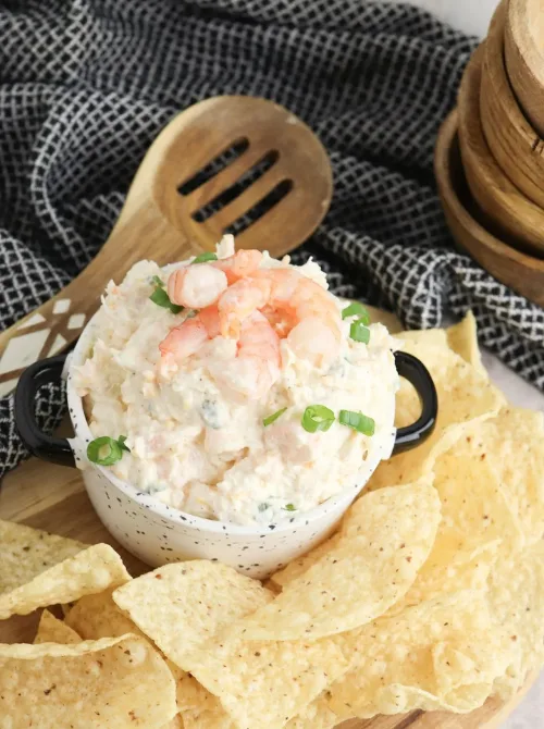 Cold seafood dip with shrimp and green onions served in a small dish alongside tortilla chips, a refreshing option for Party Dips for the Holidays with Unique Twists.