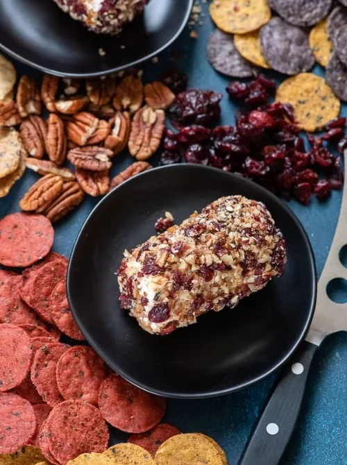Slow cooker sweet and sour meatballs served in a bowl with pineapple pieces, a warm and budget-friendly option for make-ahead Christmas appetizers and easy Christmas party food ideas.