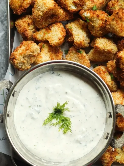 Crispy Cauliflower Bites served with creamy dill dipping sauce — a light, vegetarian option for Christmas party food ideas that’s easy to make, budget-friendly, and perfect for healthy holiday entertaining and crowd-pleasing finger food appetizers.