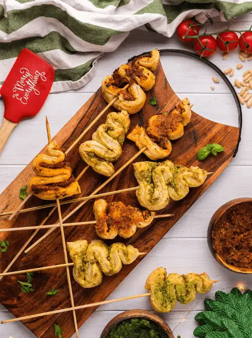 Pesto Puff Pastry Christmas Tree Appetizer twisted on wooden skewers and baked golden brown — a festive, easy finger food idea for Christmas parties that’s elegant, budget-friendly, and perfect for make-ahead holiday entertaining or quick Christmas appetizers for a crowd.