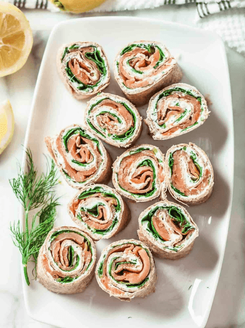 Smoked Salmon Roll-Ups Pinwheels layered with fresh spinach and herbed cream cheese — an elegant yet easy finger food appetizer for Christmas party food ideas, perfect for budget-friendly holiday entertaining, festive gatherings, and quick make-ahead Christmas appetizers.