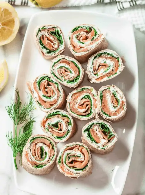 Smoked Salmon Roll-Ups Pinwheels layered with fresh spinach and herbed cream cheese — an elegant yet easy finger food appetizer for Christmas party food ideas, perfect for budget-friendly holiday entertaining, festive gatherings, and quick make-ahead Christmas appetizers.