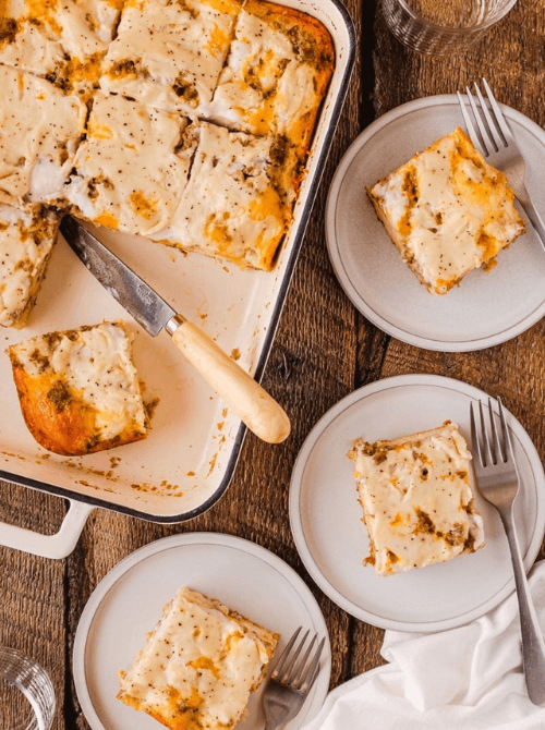 Savory breakfast casserole cut into squares and served on plates, a cozy dish perfect for Christmas morning breakfast and featured in casseroles and quiche recipes.