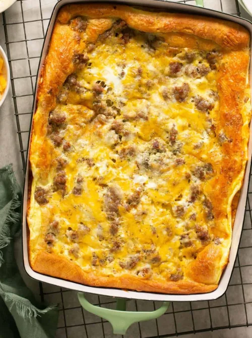 Golden crescent roll breakfast casserole filled with sausage, eggs, and cheese, an easy and comforting dish for Christmas morning breakfast featured in casseroles and quiche recipes.