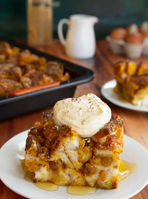Warm pumpkin breakfast casserole topped with whipped cream and syrup, perfect for a cozy Christmas morning breakfast and featured in casseroles and quiche recipes.