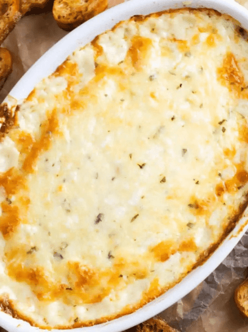 Baked cheesy garlic dip in a casserole dish, a last minute Super Bowl party dip recipe that’s perfect with bread or crackers.