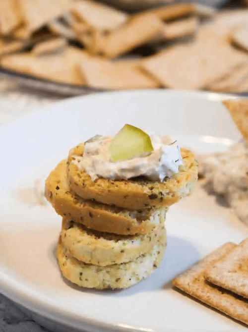 Crackers topped with creamy pickle dip and sliced pickles, a fun last minute Super Bowl party dip recipe idea.