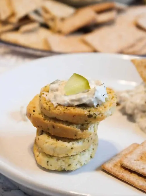Crackers topped with creamy pickle dip and sliced pickles, a fun last minute Super Bowl party dip recipe idea.